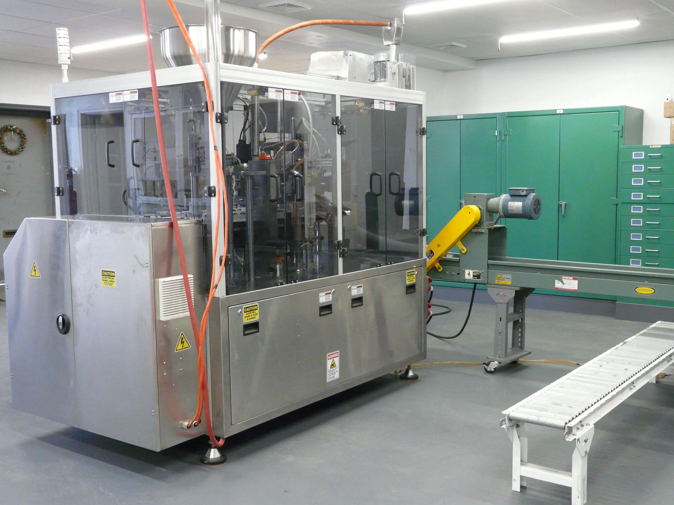 Automated industrial packaging machine in a clean factory setting.
